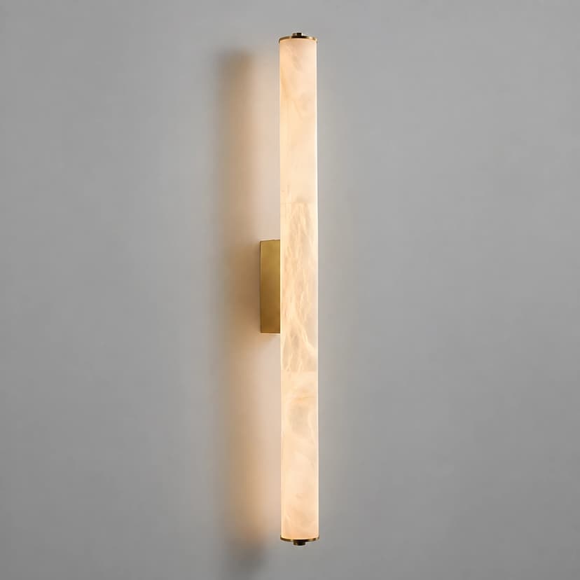 Illuminated brass vertical wall sconce with translucent marble veined cylinder diffuser