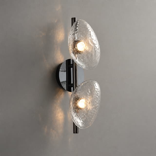 Two light modern textured glass wall sconce with organic clear pebble shades and black metal frame