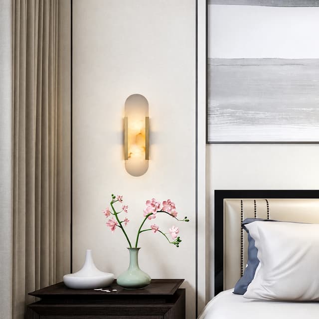 Vertical natural alabaster wall sconce beside a modern bedroom nightstand