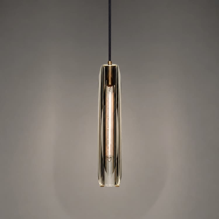 Slim clear crystal pendant light with warm copper frame and elongated sculptural design