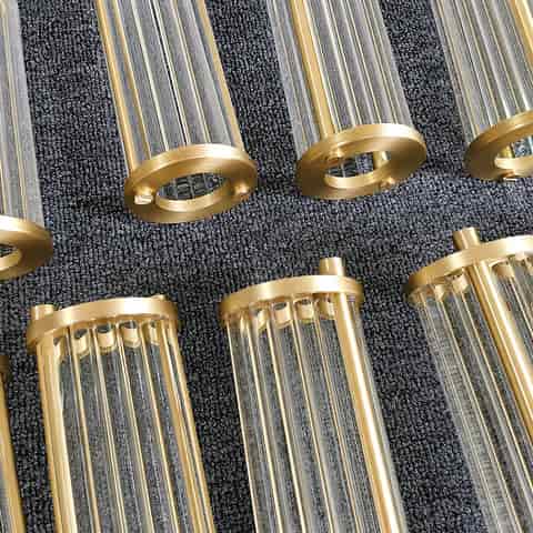 Brass finish wall sconce components with clear vertical glass rods and round trim rings