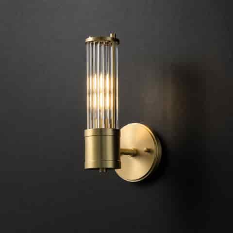Single brass finish glass rod wall sconce with cylindrical body on a dark wall