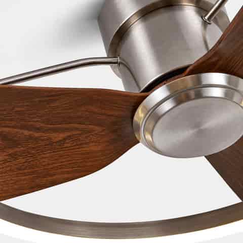 Close up of the sand nickel metal motor housing, curved support arms and wood grain fan blade detail