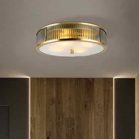 Copper fluted glass flush mount ceiling light with frosted glass diffuser in a modern hallway