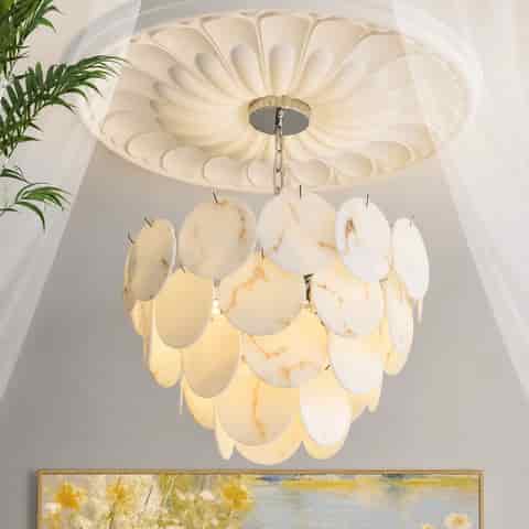 Faux alabaster chandelier glowing warmly in a bright residential interior with layered translucent marble look discs