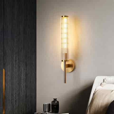 Gold fluted glass and copper wall sconce in a modern bedroom