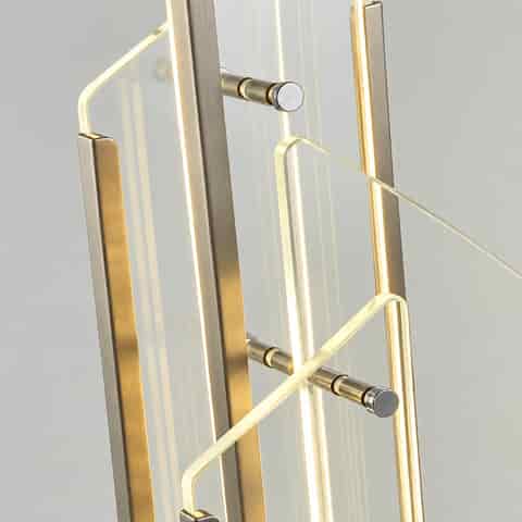 Close up of layered clear glass panels, black metal frame and integrated LED light on a modern wall sconce