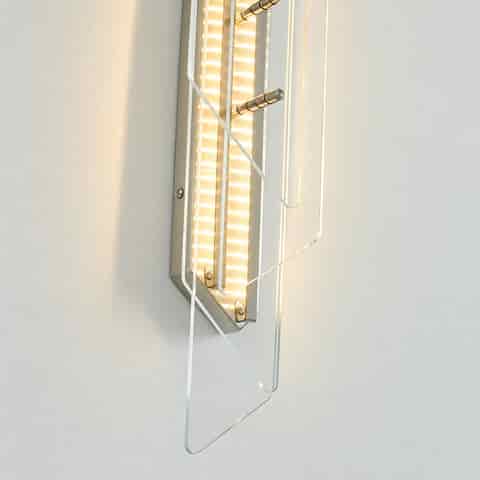 Detailed view of transparent geometric glass panels and black metal structure on an LED wall light