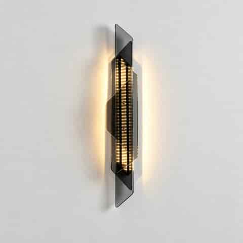Black geometric LED wall sconce with transparent glass panels and warm wall washing light