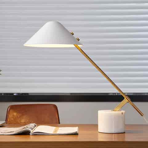White modern cantilever table lamp with an ivory natural stone base and polished gold metal frame